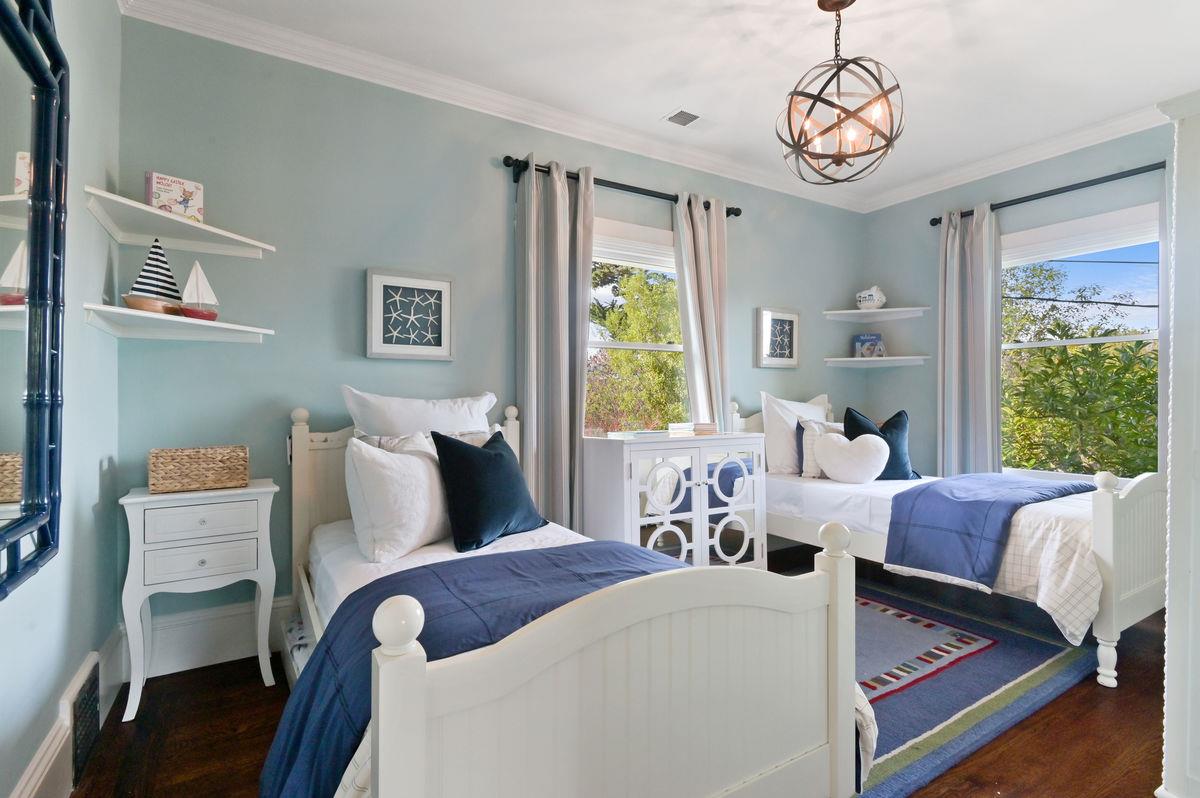 224 Warren Road San Mateo, CA 94402 - Photo 26 of 36 a bedroom with a bed and a chandelier