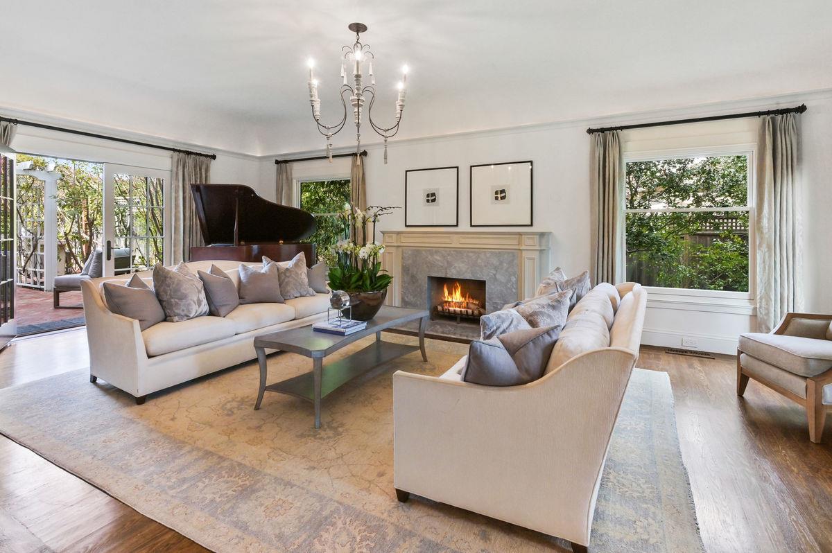 224 Warren Road San Mateo, CA 94402 - Photo 4 of 36 a living room with furniture a chandelier and a fireplace