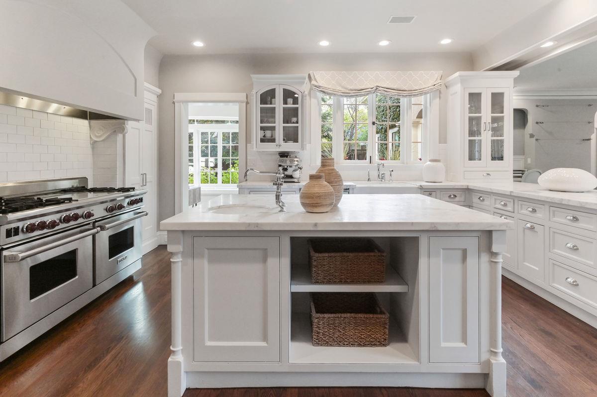 224 Warren Road San Mateo, CA 94402 - Photo 9 of 36 a kitchen with stainless steel appliances granite countertop a stove and a sink