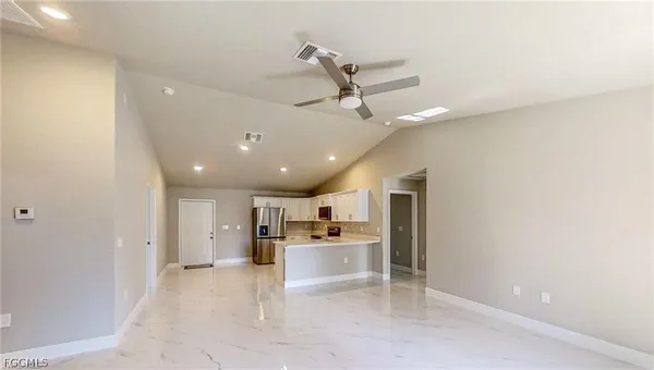 a view of a kitchen with a sink and a refrigerator