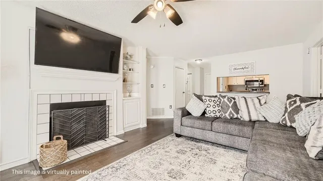 a living room with furniture a flat screen tv and a fireplace