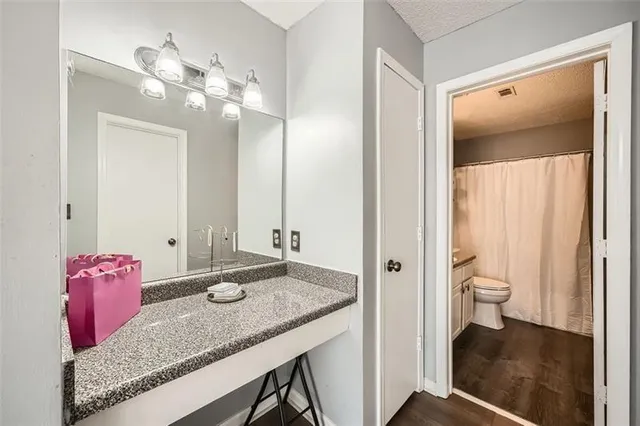 a bathroom with a granite countertop sink and a mirror