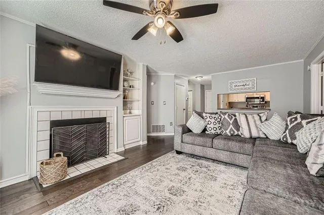 a living room with furniture a flat screen tv and a fireplace