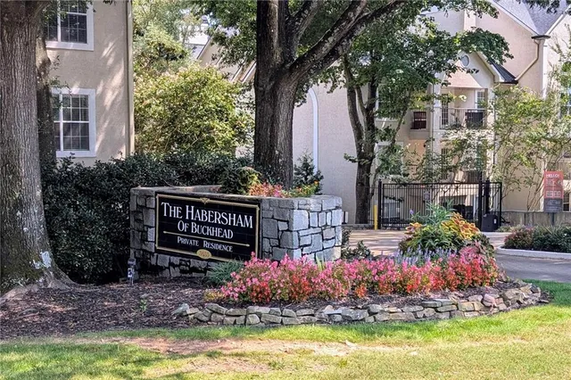 a view of a house with a yard and potted plants