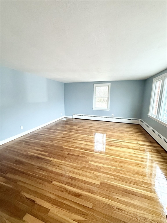 371 Wilbraham Street, Unit 1 Palmer, MA 01069 - Photo 5 of 21 a view of empty room with window and wooden floor