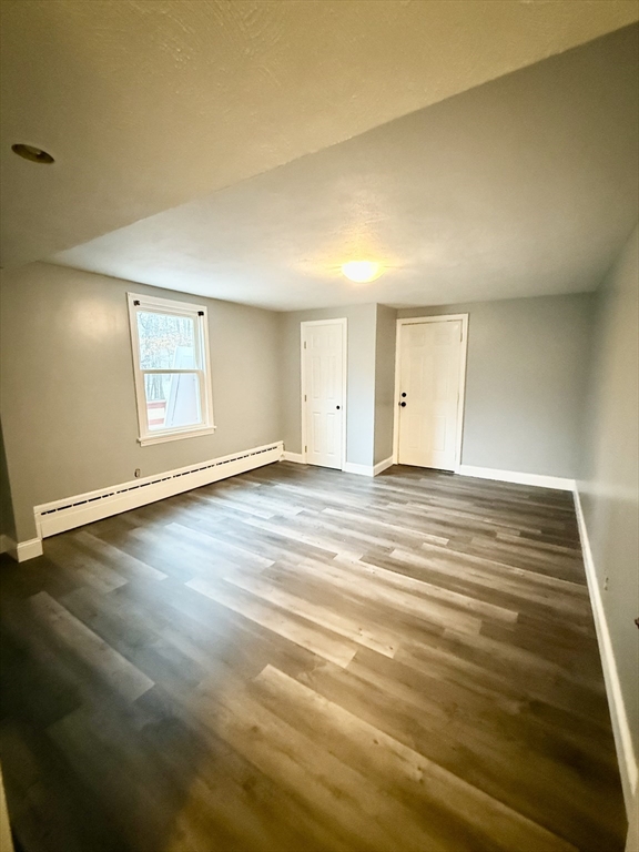 371 Wilbraham Street, Unit 1 Palmer, MA 01069 - Photo 9 of 21 a view of an empty room with window and wooden floor