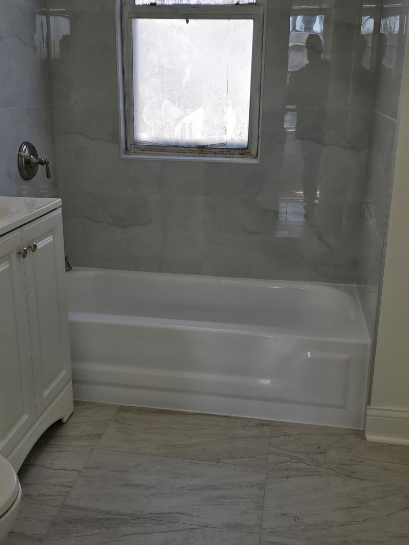 10758 South Indiana Avenue, Unit 2 Chicago, IL 60628 - Photo 5 of 8 a bathroom with a bathtub
