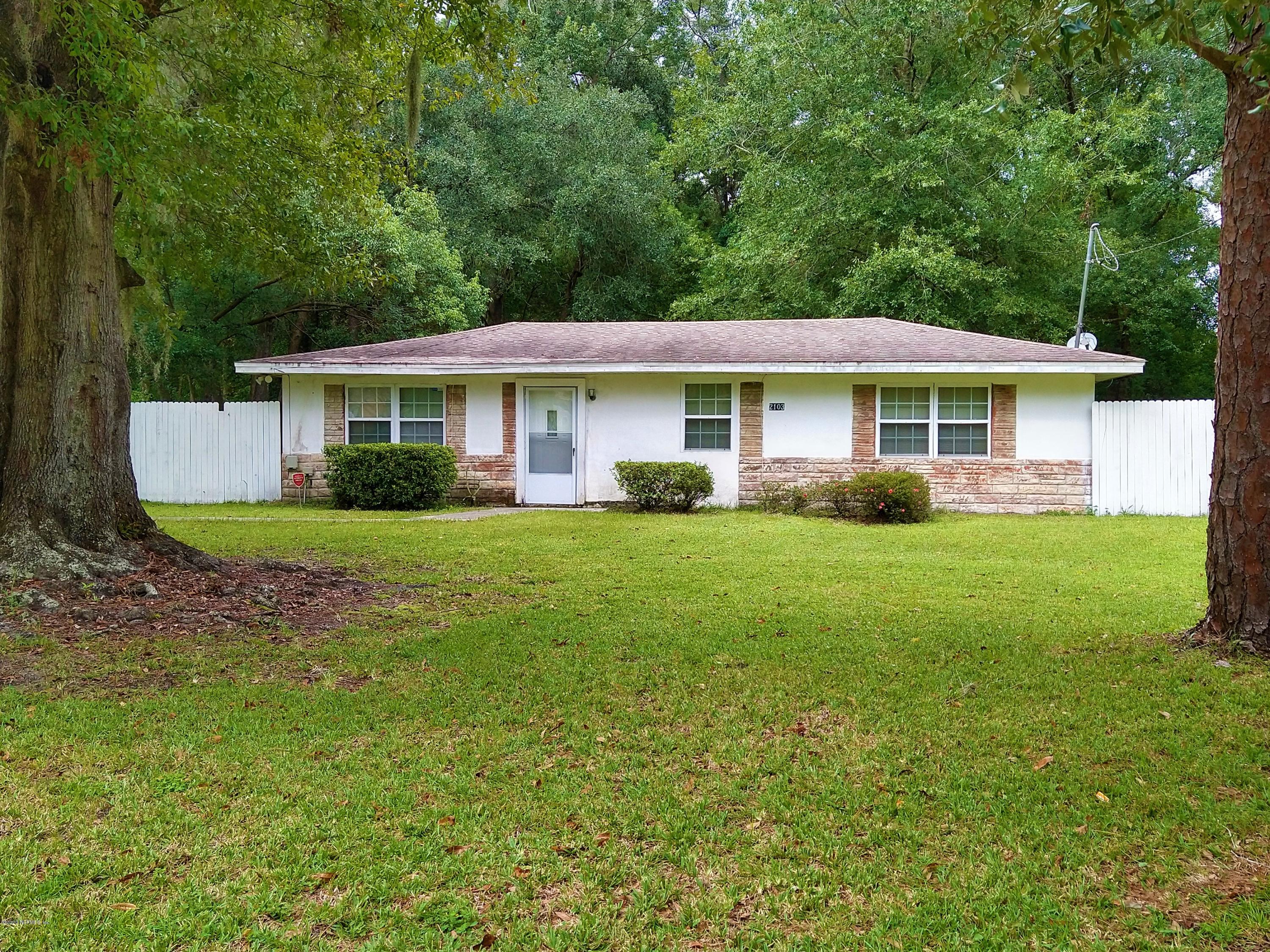 2103 Benedict Road Jacksonville, FL 32209 - Photo 1 of 35 a view of a house with a yard and potted plants