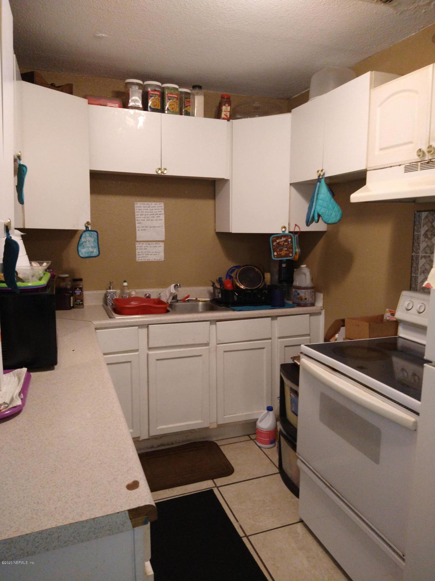 2103 Benedict Road Jacksonville, FL 32209 - Photo 6 of 35 a kitchen with granite countertop a sink stove and cabinets