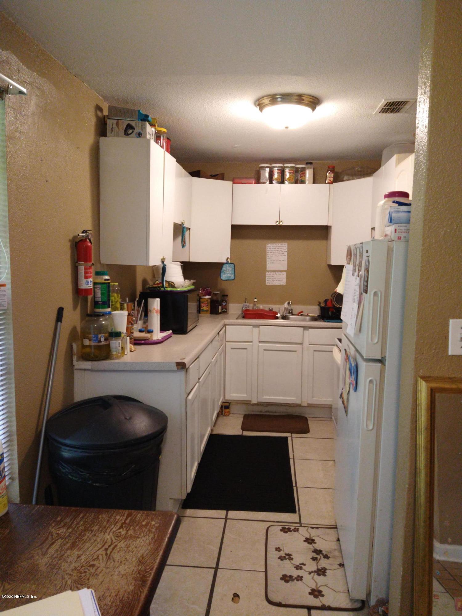 2103 Benedict Road Jacksonville, FL 32209 - Photo 7 of 35 a kitchen with a sink a stove and refrigerator