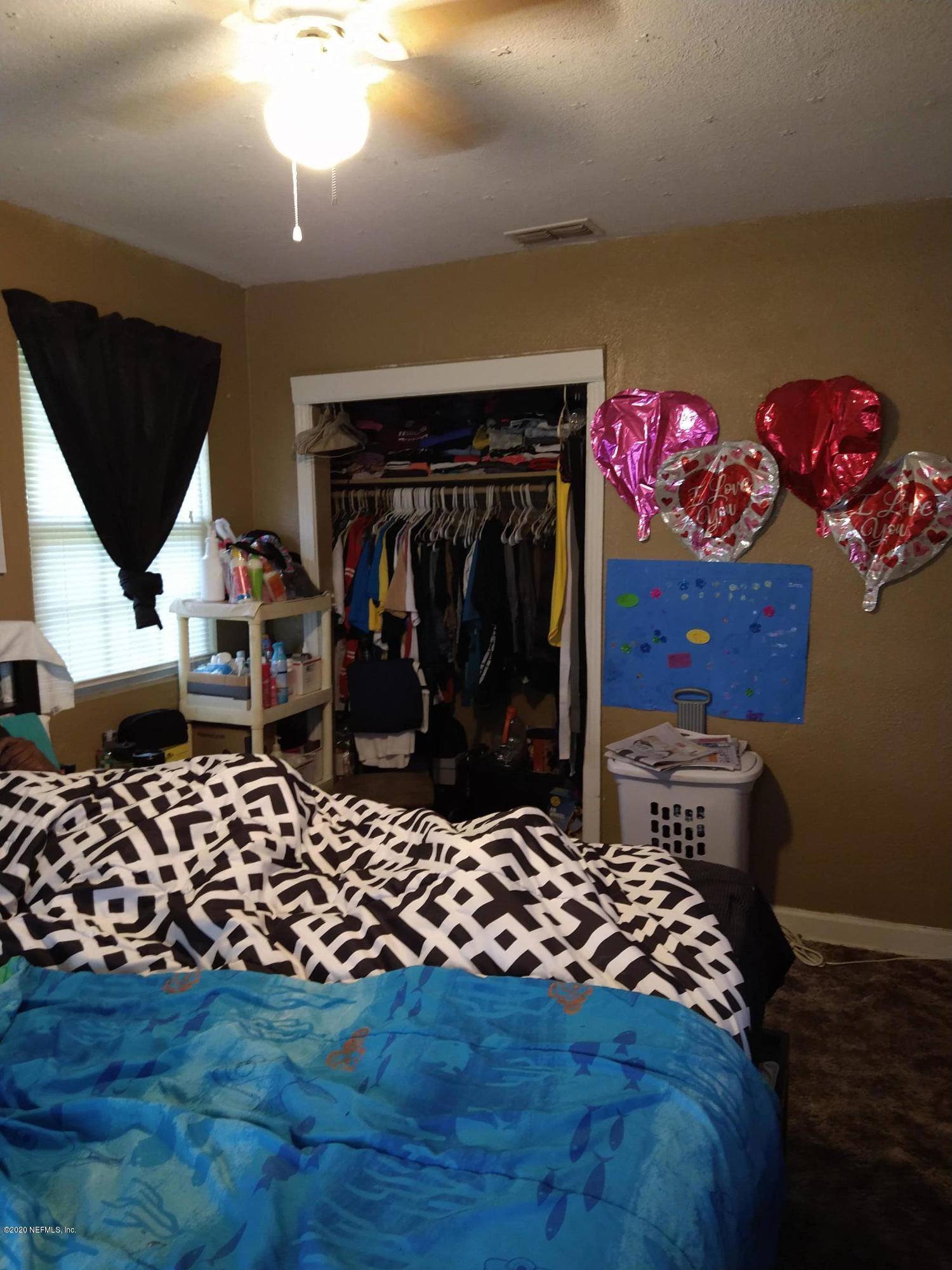 2103 Benedict Road Jacksonville, FL 32209 - Photo 10 of 35 a bedroom with a bed and wooden floor