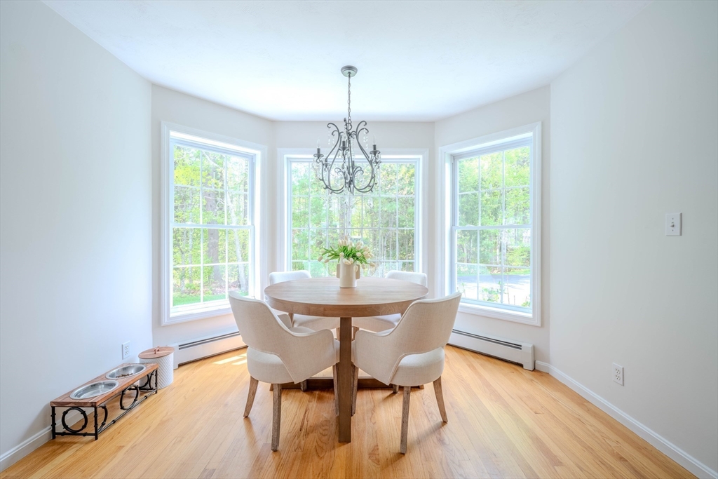 18 Dominitis Drive Holden, MA 01522 - Photo 11 of 41 a dining room with furniture a chandelier and wooden floor