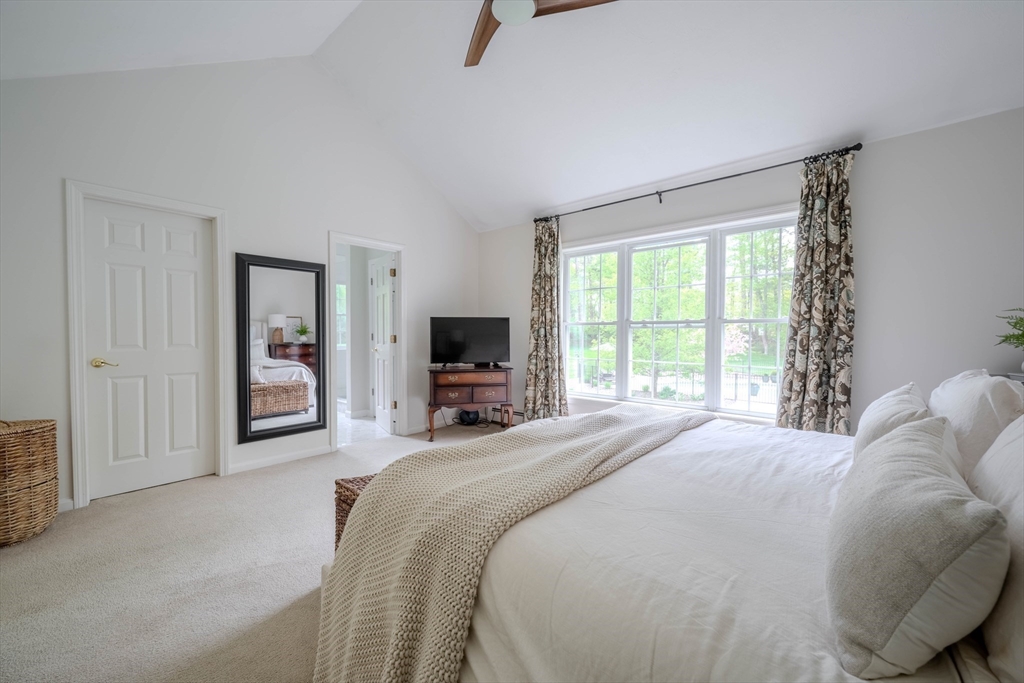 18 Dominitis Drive Holden, MA 01522 - Photo 14 of 41 a bedroom with a bed a television and a large window