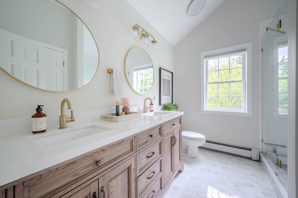 18 Dominitis Drive Holden, MA 01522 - Photo 15 of 41 a spacious bathroom with a double vanity sink a toilet and a mirror