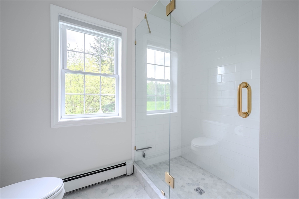 18 Dominitis Drive Holden, MA 01522 - Photo 16 of 41 a bathroom with a shower a toilet and a window