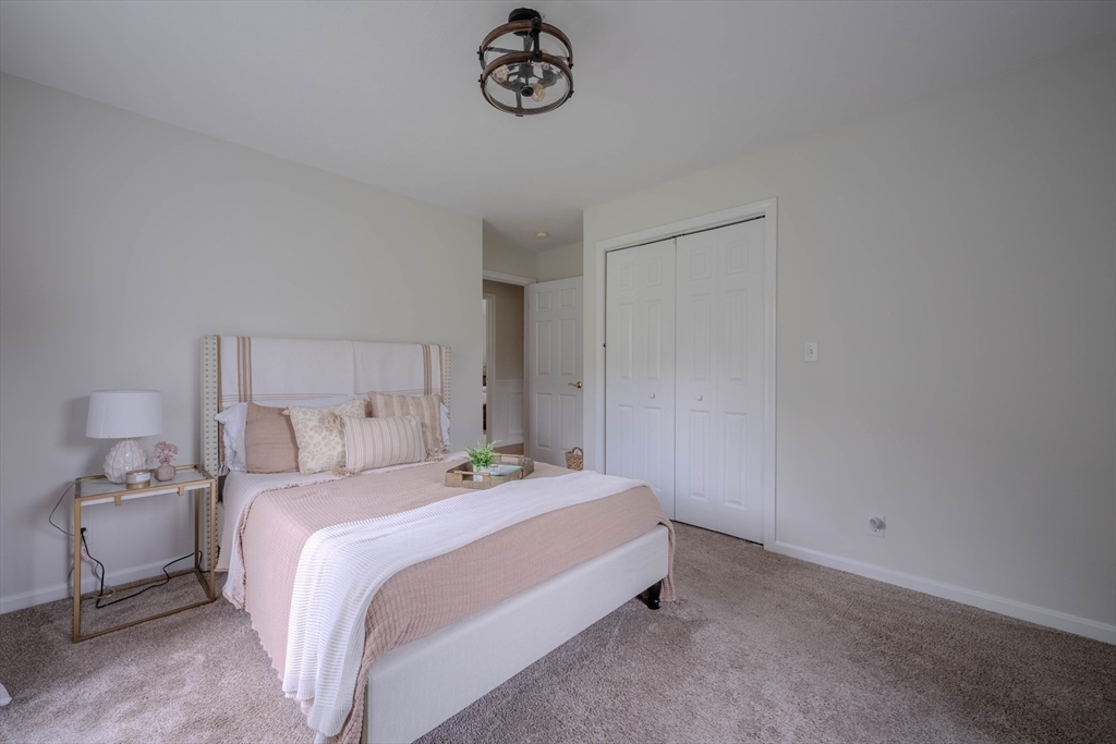 18 Dominitis Drive Holden, MA 01522 - Photo 17 of 41 a bedroom with a bed and a chandelier