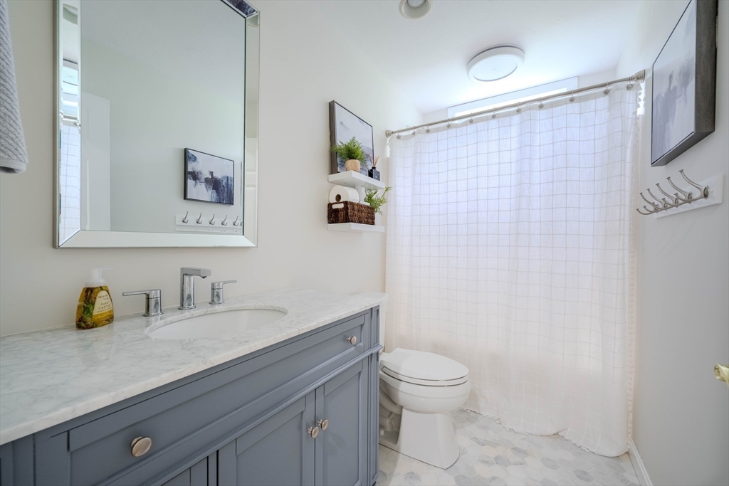 18 Dominitis Drive Holden, MA 01522 - Photo 19 of 41 a bathroom with a granite countertop sink a toilet and a shower