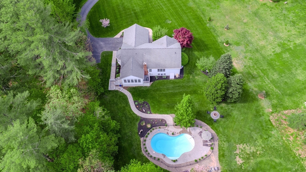 18 Dominitis Drive Holden, MA 01522 - Photo 2 of 41 an aerial view of a house with table chairs and a fire pit