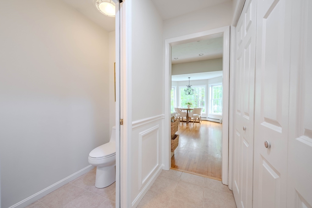 18 Dominitis Drive Holden, MA 01522 - Photo 22 of 41 a view of a hallway with wooden floor a glass door and a bathroom
