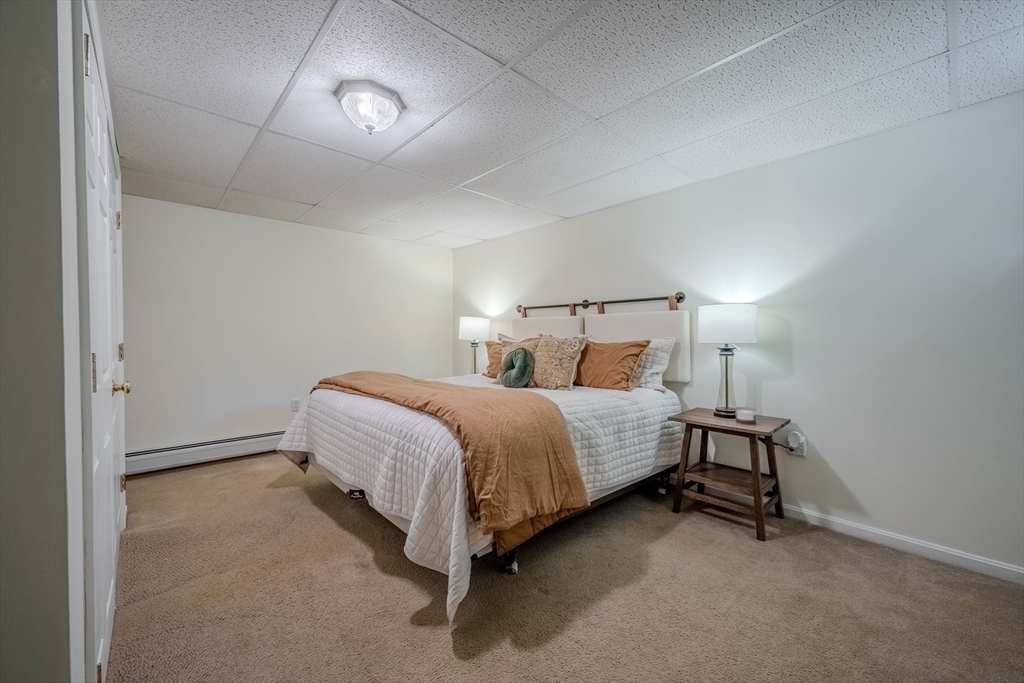 18 Dominitis Drive Holden, MA 01522 - Photo 26 of 41 a bedroom with a bed and a lamp