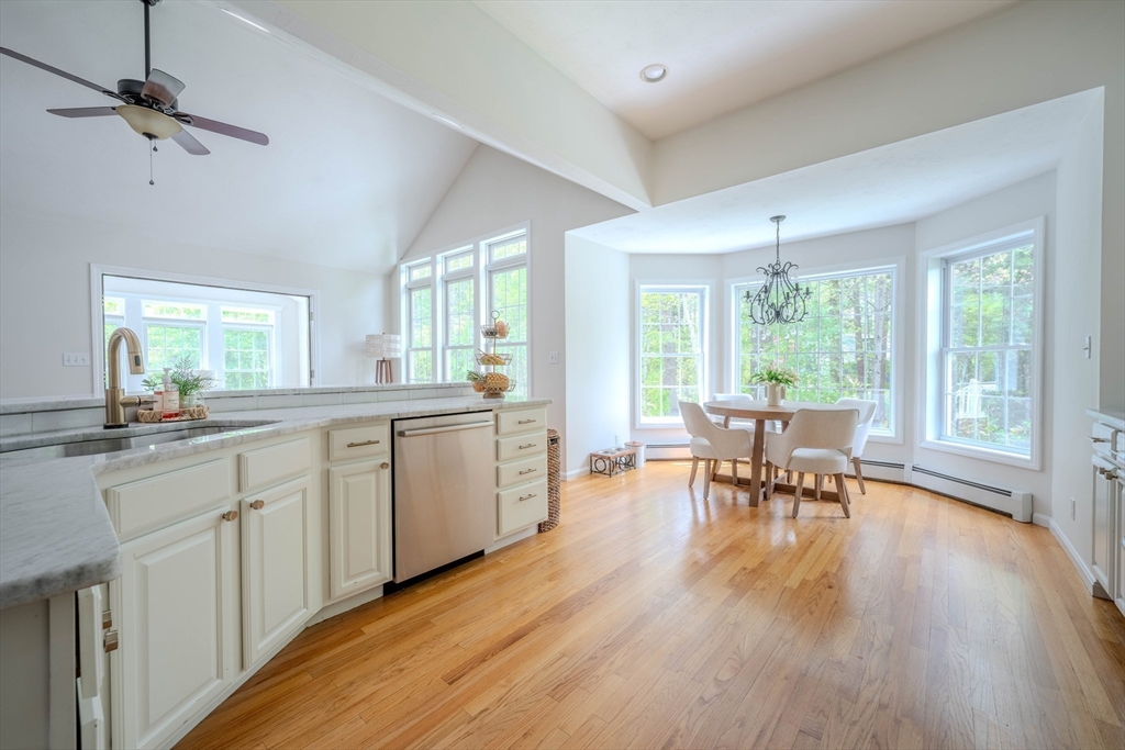 18 Dominitis Drive Holden, MA 01522 - Photo 10 of 41 a kitchen with stainless steel appliances granite countertop dining table chairs sink and wooden floor