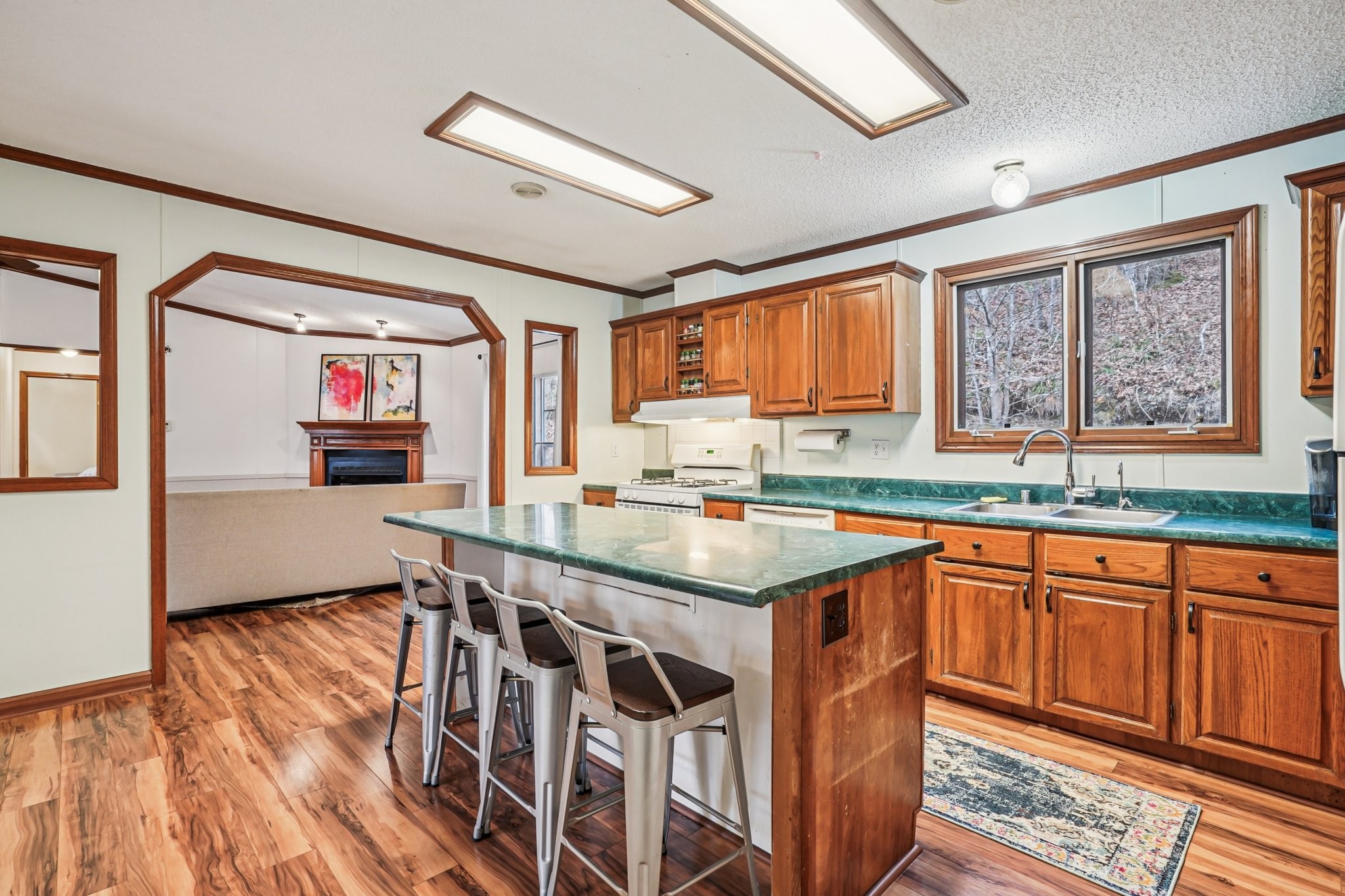 3668 Old Sams Creek Road Pegram, TN 37143 - Photo 19 of 60 a kitchen with stainless steel appliances granite countertop a sink and wooden cabinets