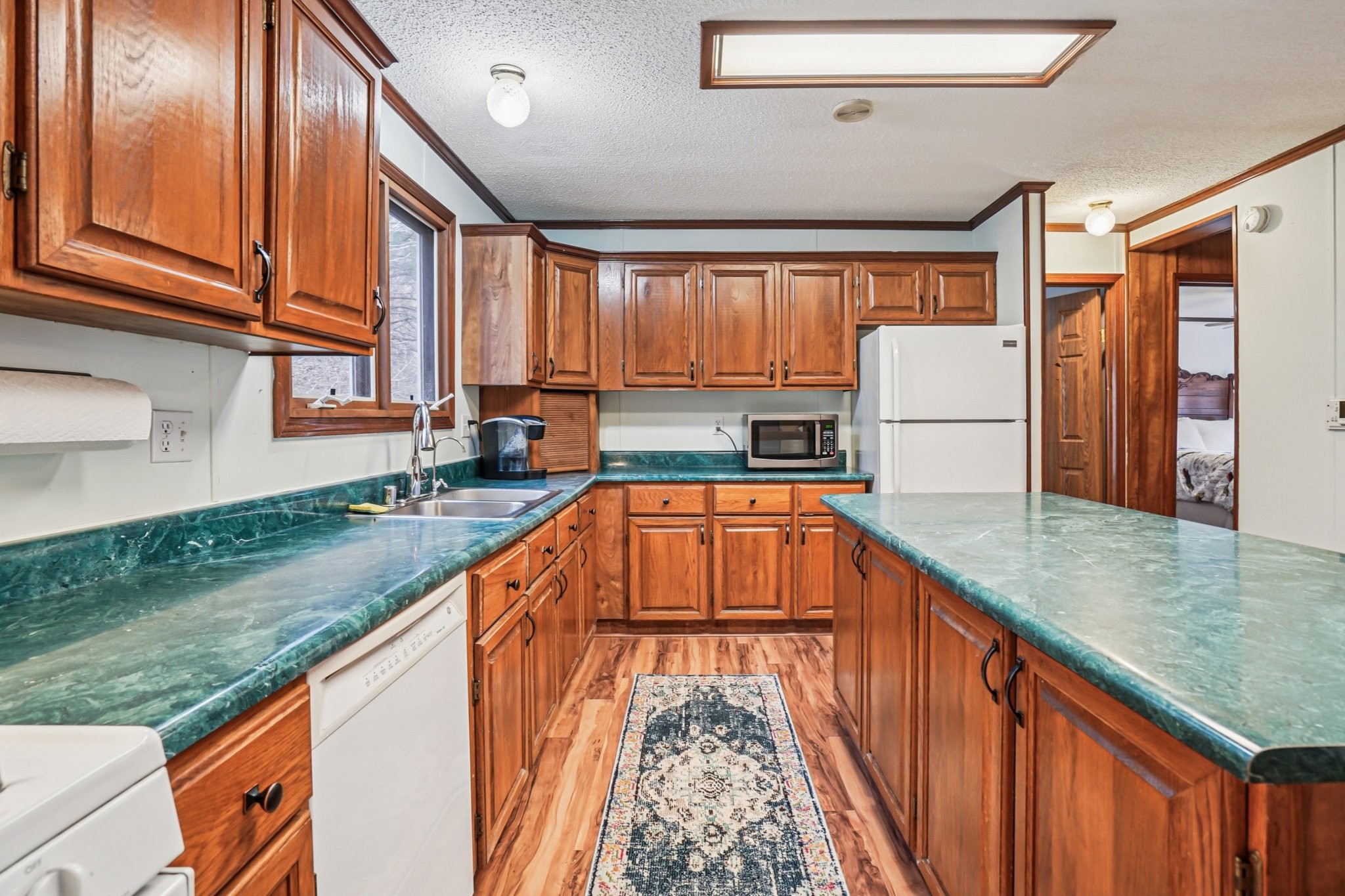 3668 Old Sams Creek Road Pegram, TN 37143 - Photo 20 of 60 a kitchen with kitchen island granite countertop a sink a counter space and stainless steel appliances