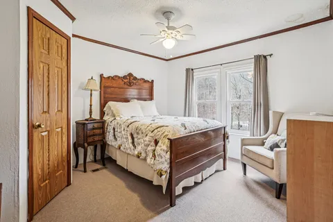 a spacious bedroom with a bed and window