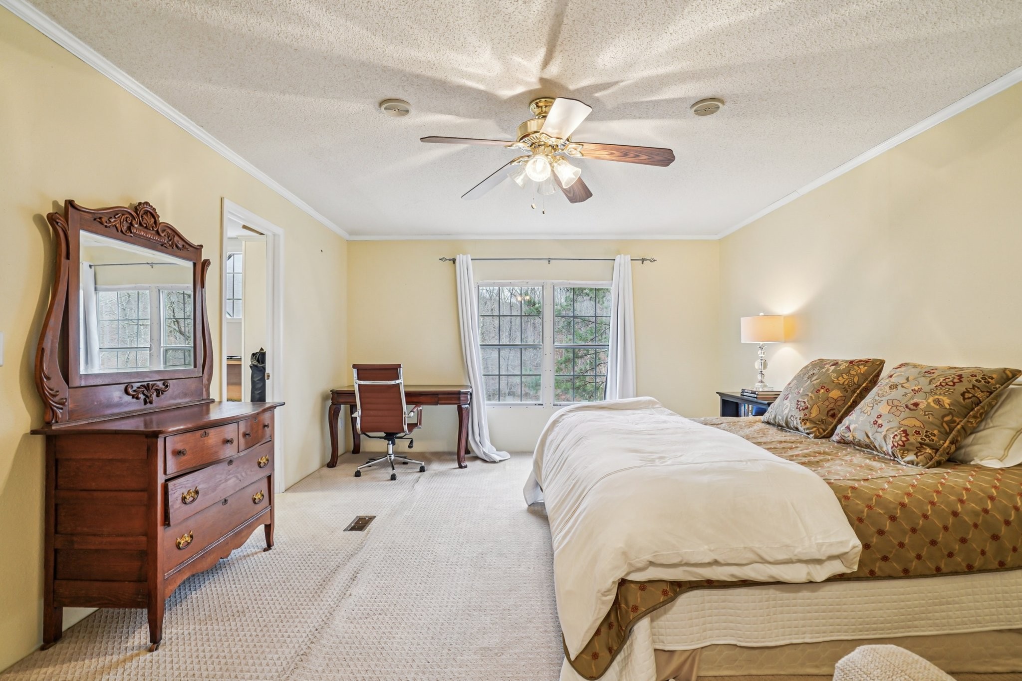 3668 Old Sams Creek Road Pegram, TN 37143 - Photo 26 of 60 a spacious bedroom with a bed and ceiling fan
