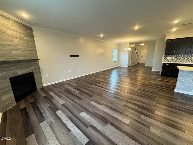 a view of an empty room and wooden floor