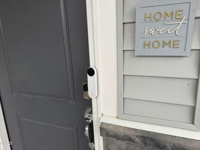 a kitchen with stainless steel appliances granite countertop a sink dishwasher a stove and a refrigerator with wooden floor