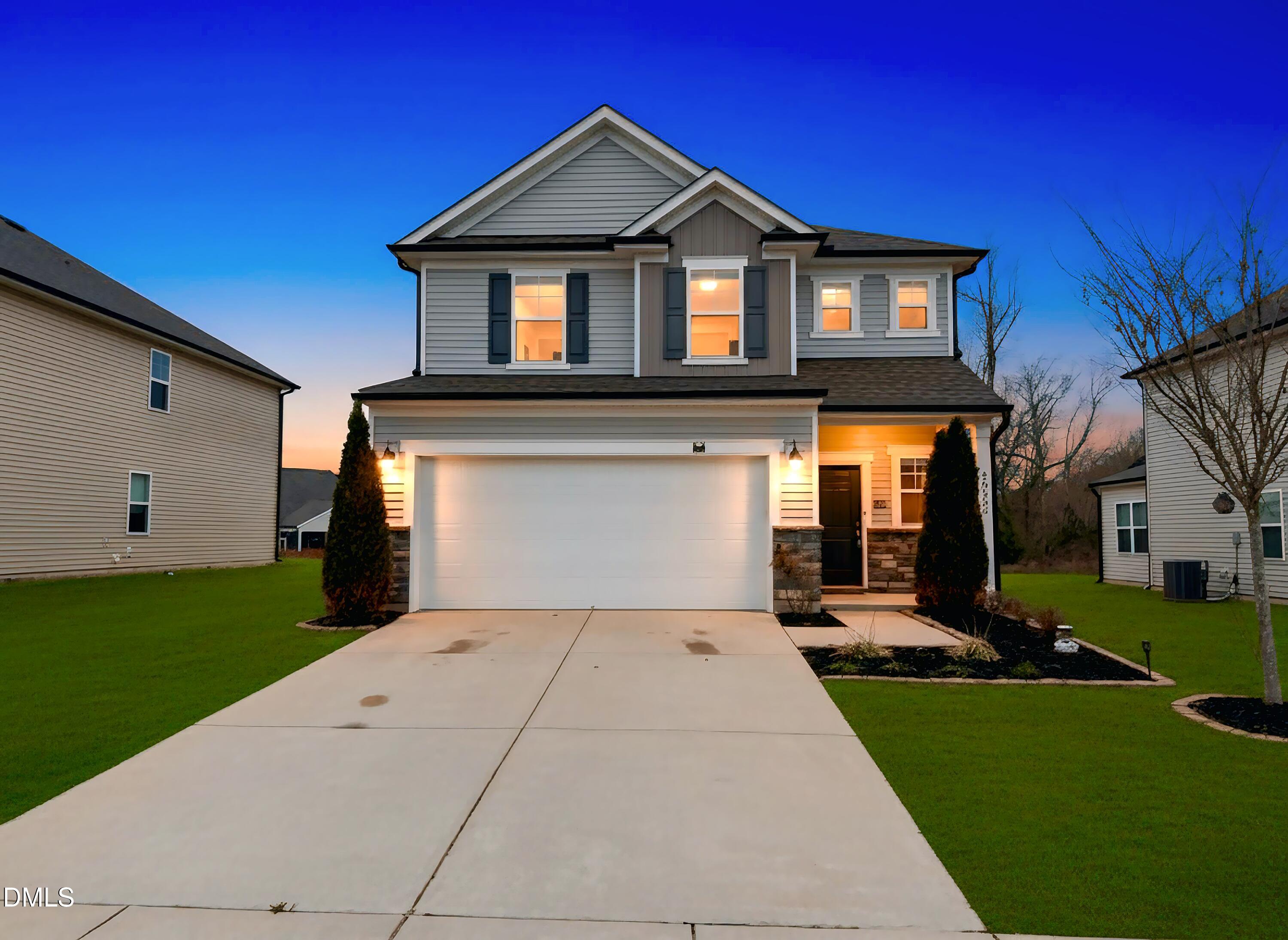 2022 Attend Crossing Fuquay-Varina, NC 27526 - Photo 43 of 43 a front view of a house with a yard and garage