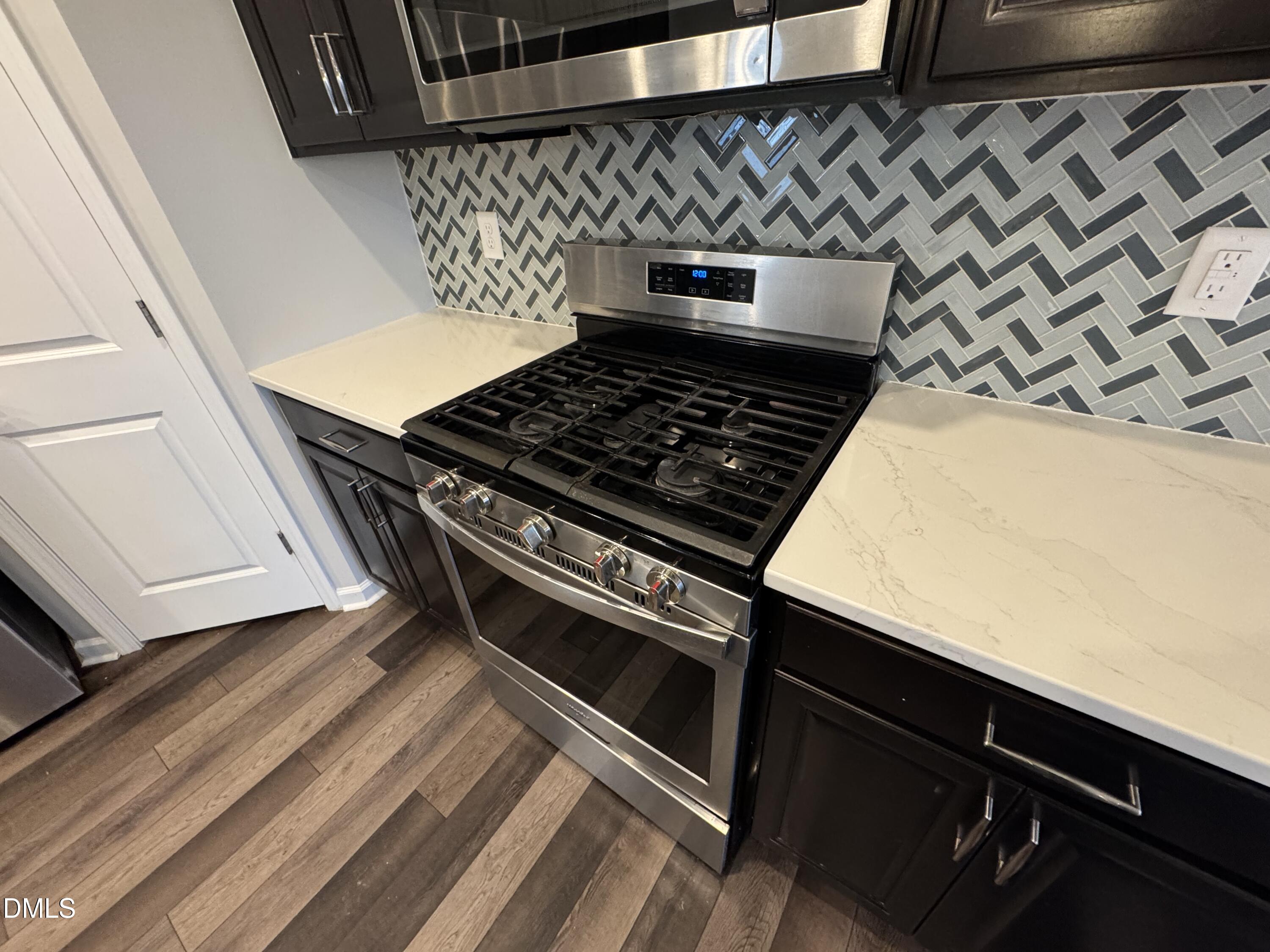 2022 Attend Crossing Fuquay-Varina, NC 27526 - Photo 6 of 43 a stove top oven sitting inside of a kitchen