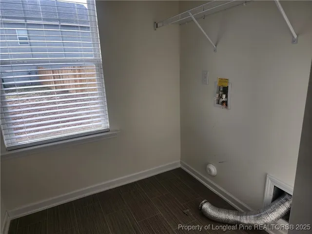 a room with a wooden floor and a window