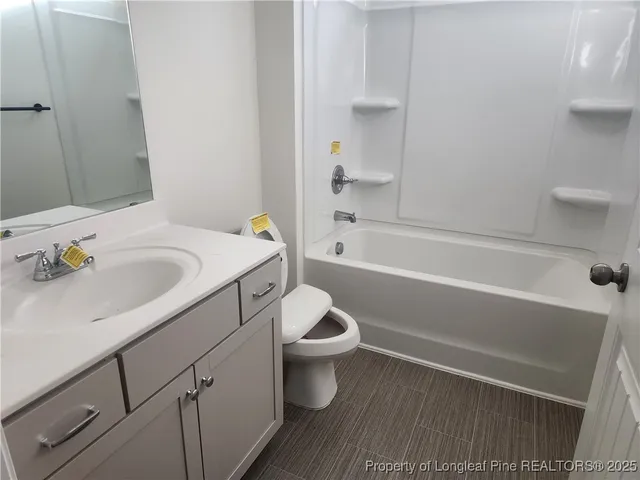 a bathroom with a sink toilet vanity and bathtub