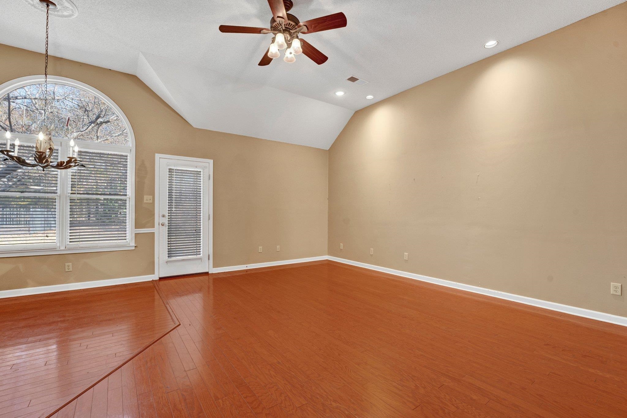 6150 Ricks Road Arlington, TN 38002 - Photo 23 of 40 Unfurnished living room featuring plenty of natural light, wood-type flooring, and vaulted ceiling