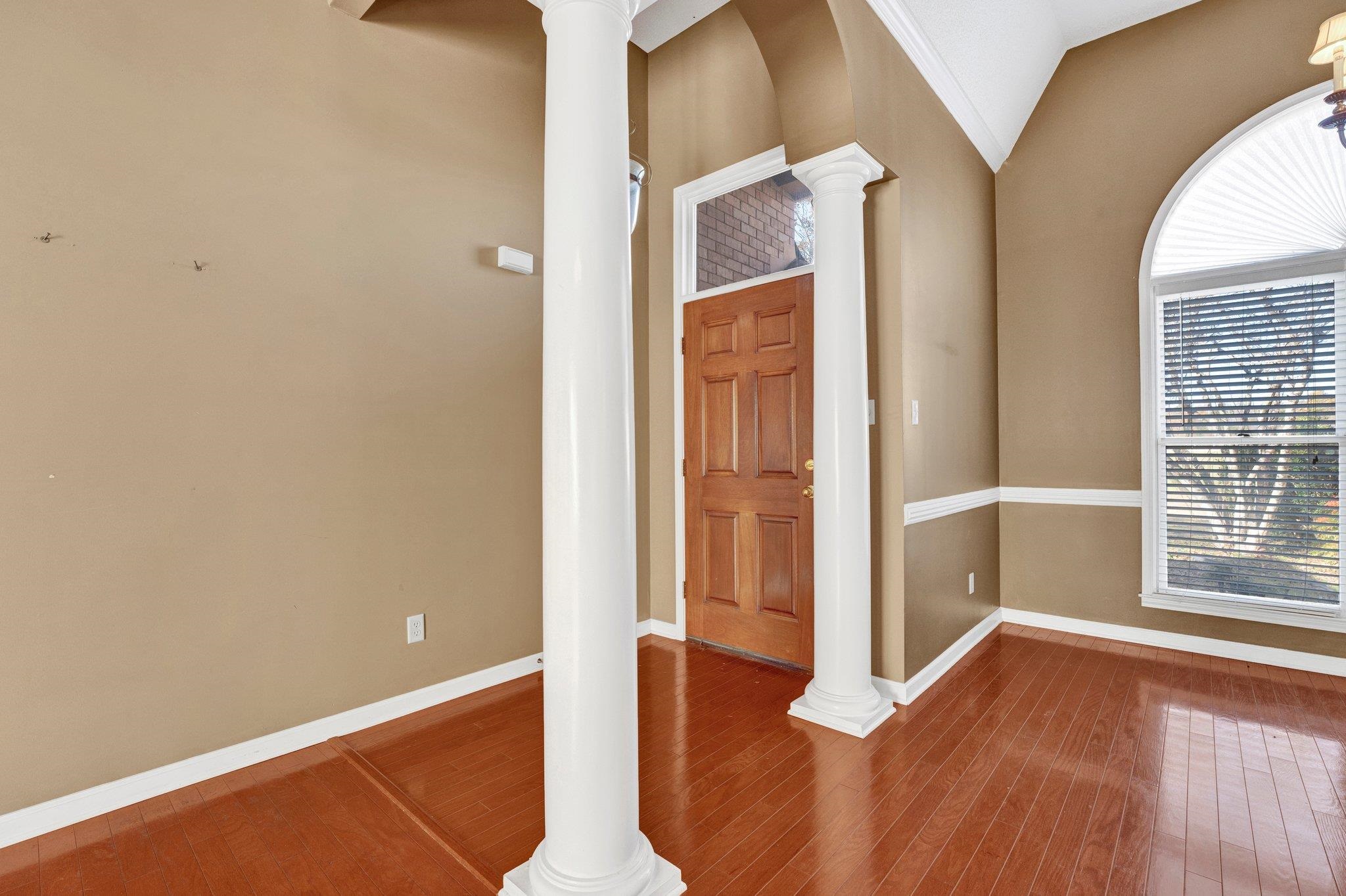 6150 Ricks Road Arlington, TN 38002 - Photo 28 of 40 Entryway featuring plenty of natural light, vaulted ceiling, wood-type flooring, and decorative columns