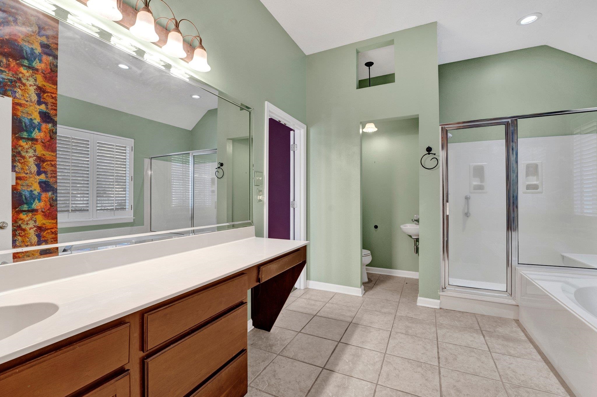 6150 Ricks Road Arlington, TN 38002 - Photo 36 of 40 Full bathroom featuring tile patterned floors, independent shower and bath, vaulted ceiling, and toilet