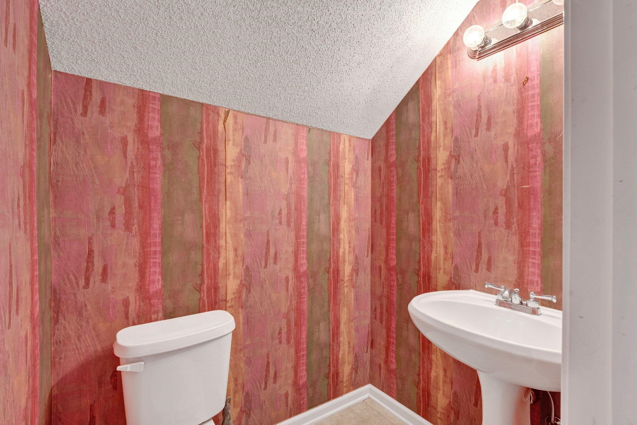 6150 Ricks Road Arlington, TN 38002 - Photo 39 of 40 Bathroom featuring toilet, wooden walls, and sink