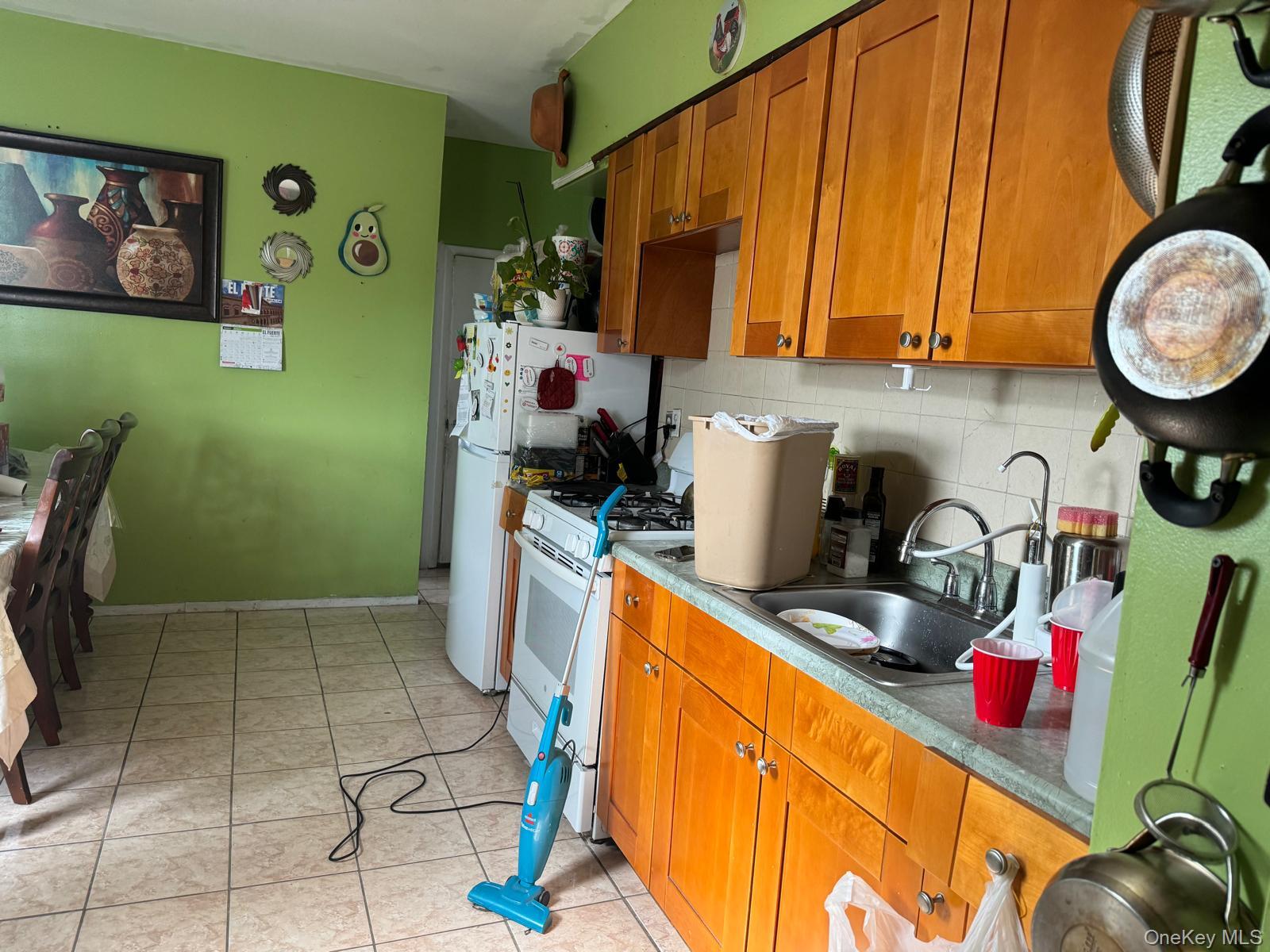 45-16 National Street Queens, NY 11368 - Photo 18 of 28 a kitchen with a refrigerator and a stove