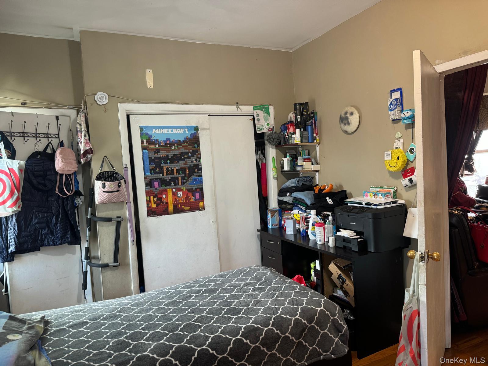45-16 National Street Queens, NY 11368 - Photo 26 of 28 a bedroom with a bed and a flat tv screen