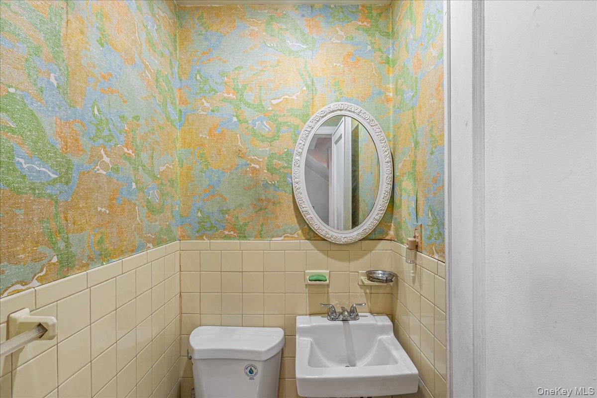 180-19 Grand Central Parkway Queens, NY 11432 - Photo 17 of 28 a bathroom with a sink and a mirror