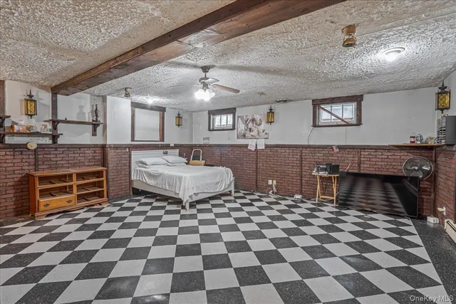 a spacious bathroom with a black and white checkered floor