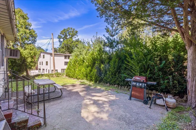 a view of a patio with table and chairs and potted plants