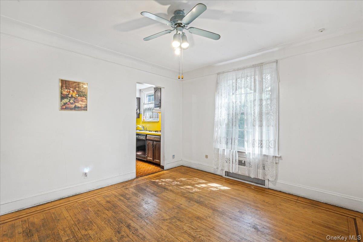 180-19 Grand Central Parkway Queens, NY 11432 - Photo 5 of 28 wooden floor in an empty room with a window
