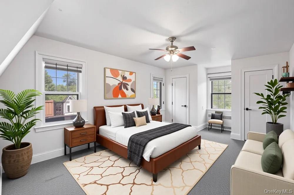 180-19 Grand Central Parkway Queens, NY 11432 - Photo 6 of 28 a bedroom with a large bed a potted plant and a window