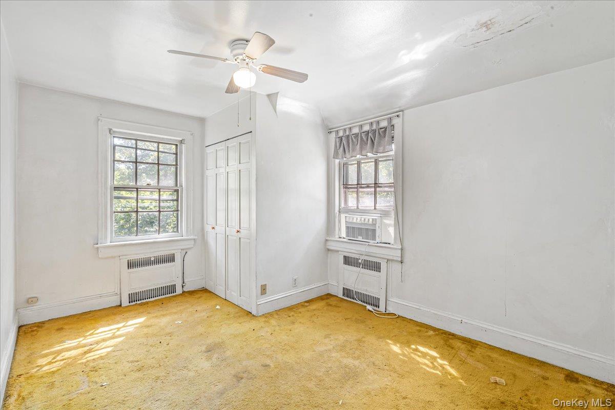 180-19 Grand Central Parkway Queens, NY 11432 - Photo 9 of 28 a view of an empty room with a window