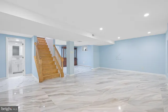 a view of an empty room with wooden floor and entryway