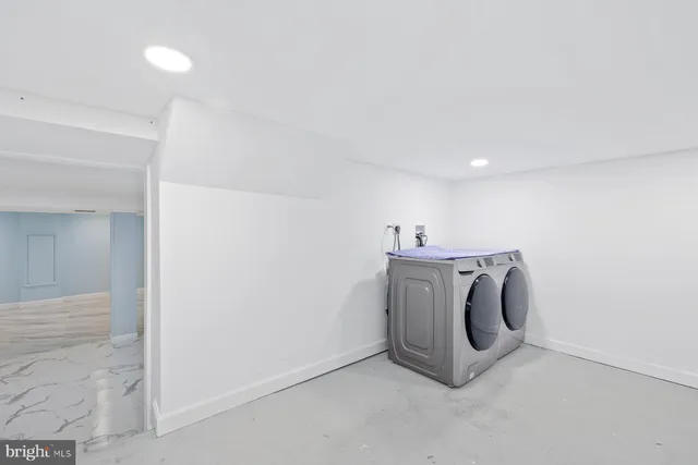 a view of a storage & utility room with a washer dryer