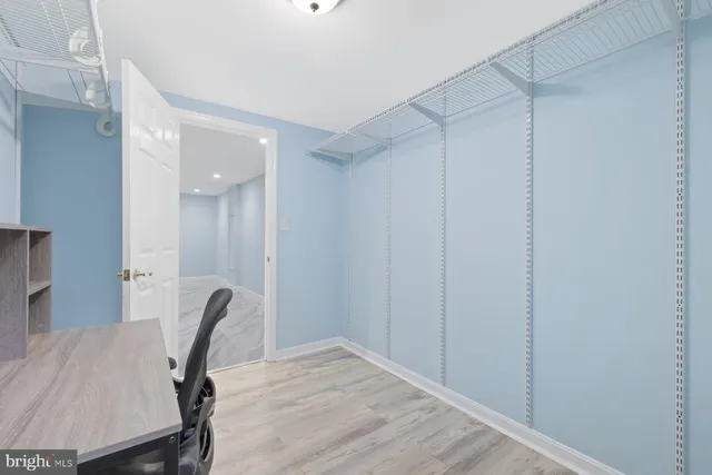 a view of a workspace with furniture and wooden floor